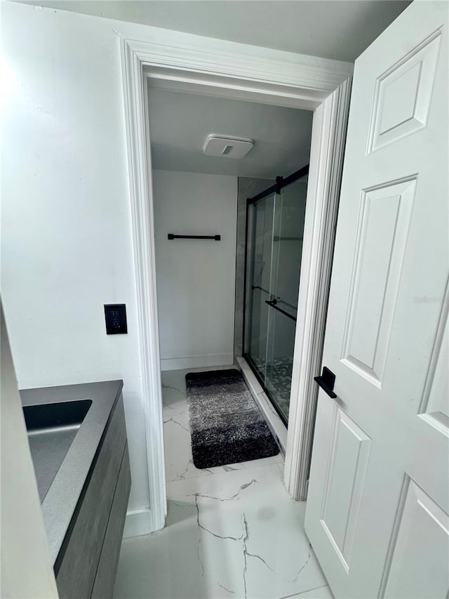 6258 Masters Blvd Unit C204, Orlando, FL 32819 - bathroom featuring marble finish flooring, a stall shower, and vanity