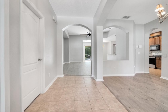 274 Wekiva Pointe Cir, Apopka, FL 32712 - entrance foyer with a ceiling fan, arched walkways, and light wood-style floors