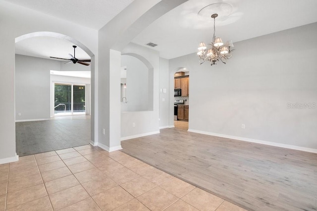 274 Wekiva Pointe Cir, Apopka, FL 32712 - unfurnished room with ceiling fan, arched walkways, light wood-style floors, and a chandelier
