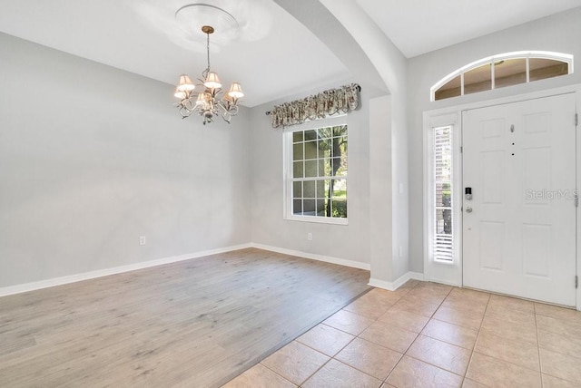 274 Wekiva Pointe Cir, Apopka, FL 32712 - foyer featuring a chandelier, arched walkways, and light wood-type flooring