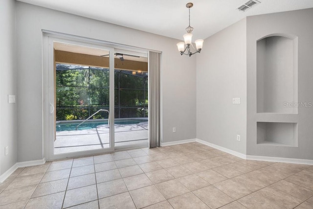 274 Wekiva Pointe Cir, Apopka, FL 32712 - spare room with light tile patterned floors, built in shelves, a chandelier, and arched walkways