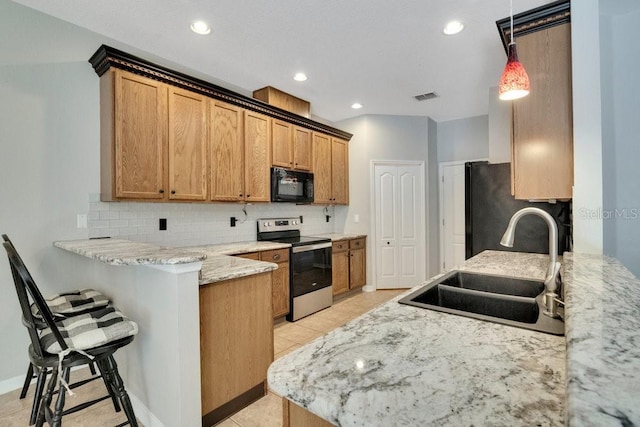 274 Wekiva Pointe Cir, Apopka, FL 32712 - kitchen with black microwave, electric range, a peninsula, decorative backsplash, and light stone counters