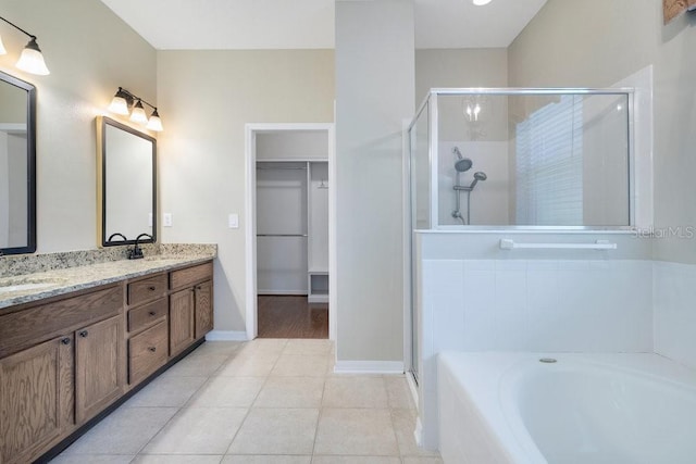 274 Wekiva Pointe Cir, Apopka, FL 32712 - full bath featuring a shower stall, a bath, a walk in closet, double vanity, and tile patterned floors