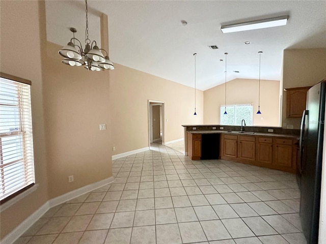 1676 Vick Rd, Apopka, FL 32712 - kitchen featuring freestanding refrigerator, a chandelier, light tile patterned floors, decorative light fixtures, and high vaulted ceiling