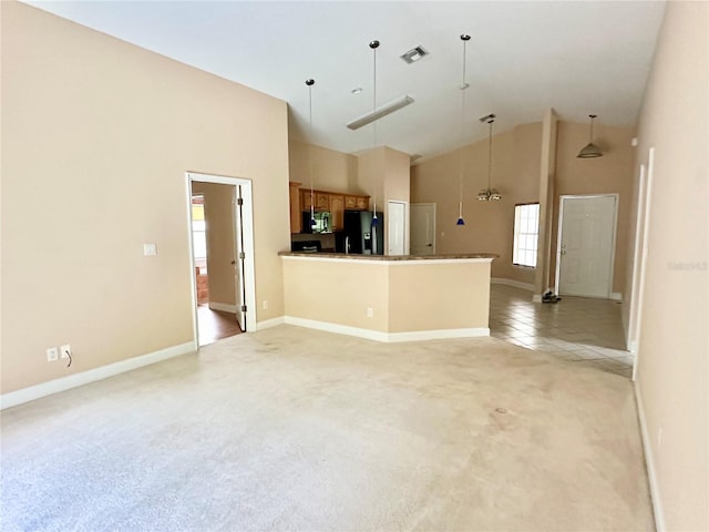 1676 Vick Rd, Apopka, FL 32712 - kitchen featuring black appliances, light colored carpet, high vaulted ceiling, brown cabinets, and open floor plan