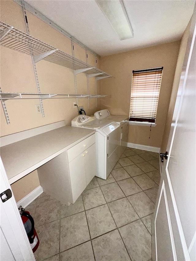 1676 Vick Rd, Apopka, FL 32712 - laundry area with independent washer and dryer, light tile patterned floors, and cabinet space