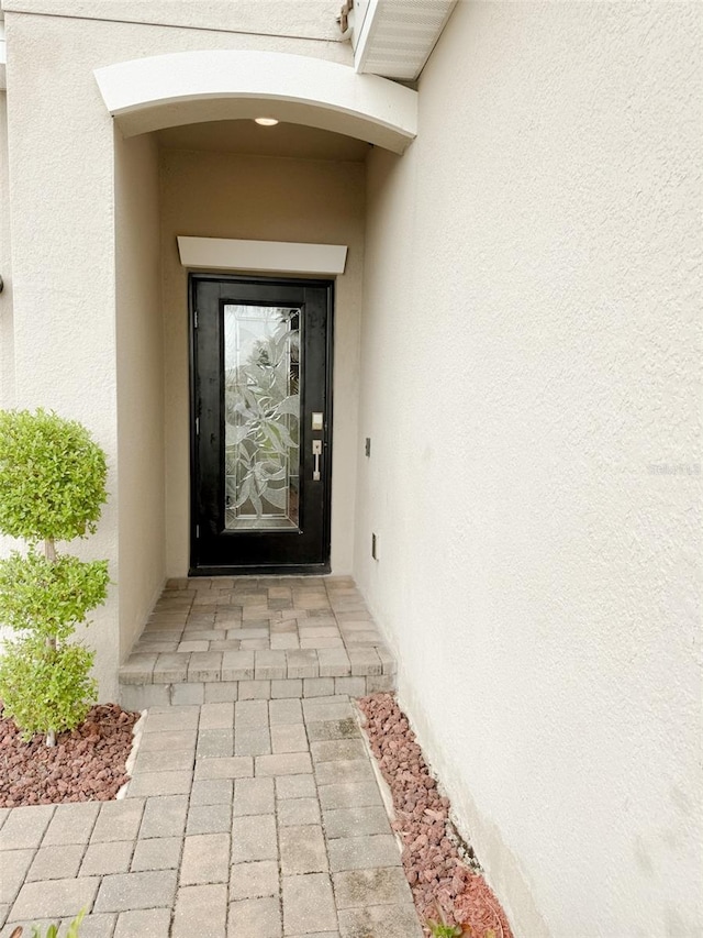 1047 Oak Bluff Dr, Davenport, FL 33837 - doorway to property with stucco siding