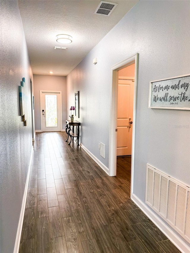 1047 Oak Bluff Dr, Davenport, FL 33837 - corridor with dark wood finished floors and a textured ceiling