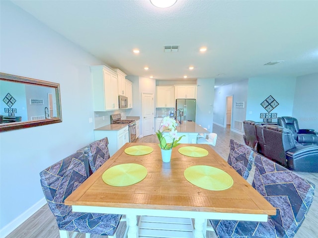1047 Oak Bluff Dr, Davenport, FL 33837 - dining space with light wood-type flooring and recessed lighting