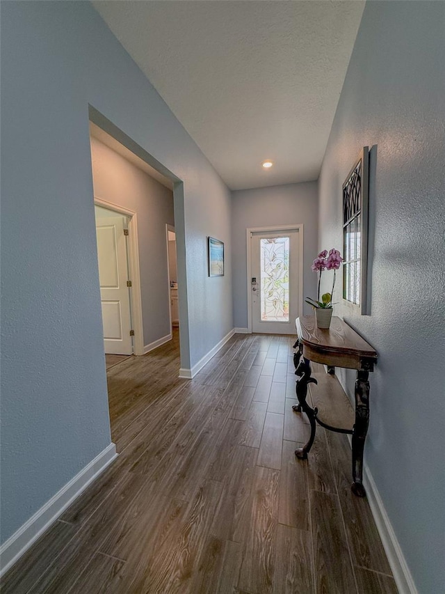 1047 Oak Bluff Dr, Davenport, FL 33837 - foyer with dark wood-type flooring and baseboards