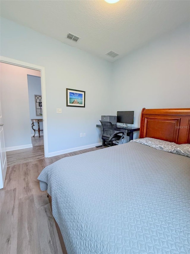 1047 Oak Bluff Dr, Davenport, FL 33837 - bedroom with light wood-style floors and a desk