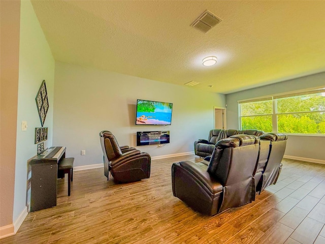 1047 Oak Bluff Dr, Davenport, FL 33837 - living area with wood finished floors and a textured ceiling