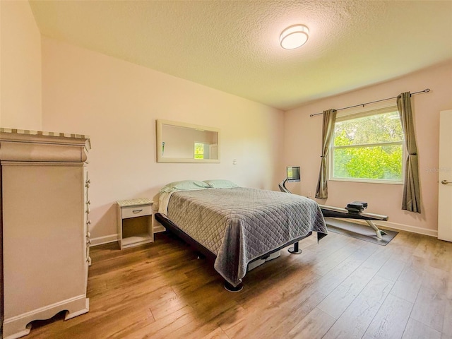 1047 Oak Bluff Dr, Davenport, FL 33837 - bedroom with hardwood / wood-style flooring and a textured ceiling