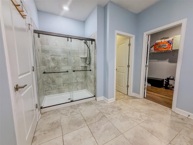 1047 Oak Bluff Dr, Davenport, FL 33837 - bathroom with a stall shower, a walk in closet, and tile patterned flooring