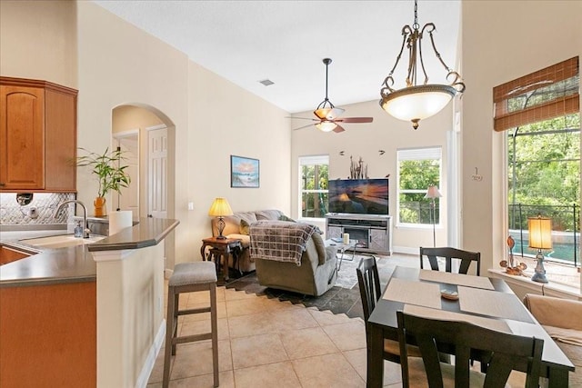 4080 Safflower Ter, Oviedo, FL 32766 - dining space with high vaulted ceiling, arched walkways, a ceiling fan, and light tile patterned floors