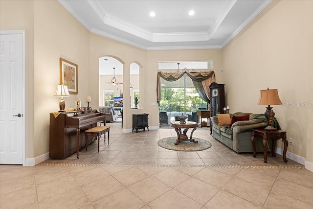 4080 Safflower Ter, Oviedo, FL 32766 - living area with a raised ceiling, healthy amount of natural light, light tile patterned floors, crown molding, and a high ceiling