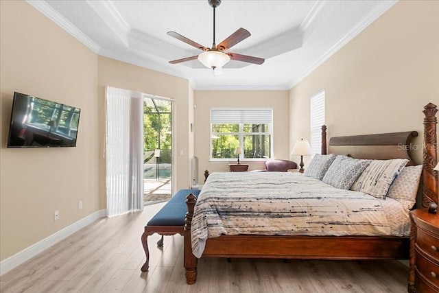 4080 Safflower Ter, Oviedo, FL 32766 - bedroom with a tray ceiling, access to exterior, crown molding, and light wood-style floors