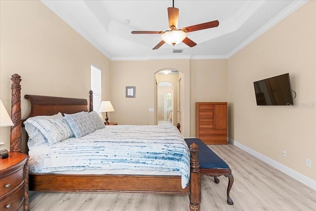 4080 Safflower Ter, Oviedo, FL 32766 - bedroom featuring a raised ceiling, wood finished floors, arched walkways, ornamental molding, and a ceiling fan