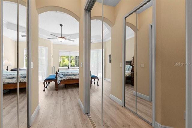 4080 Safflower Ter, Oviedo, FL 32766 - bedroom with arched walkways, light wood-type flooring, and a tray ceiling