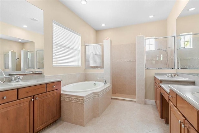 4080 Safflower Ter, Oviedo, FL 32766 - bathroom with walk in shower, a garden tub, two vanities, tile patterned floors, and recessed lighting