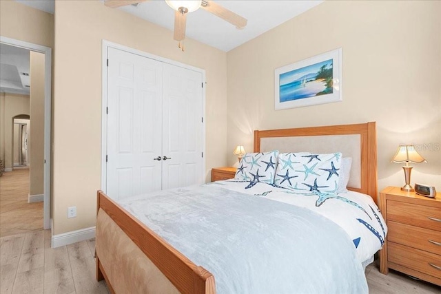 4080 Safflower Ter, Oviedo, FL 32766 - bedroom with light wood-type flooring, a closet, arched walkways, and a ceiling fan