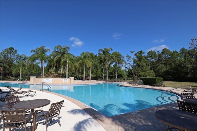 4080 Safflower Ter, Oviedo, FL 32766 - community pool featuring view of scattered trees and a patio area