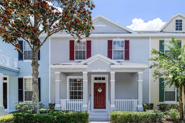 14466 Bridgewater Crossings Blvd, Windermere, FL 34786 - townhome / multi-family property with stucco siding and covered porch