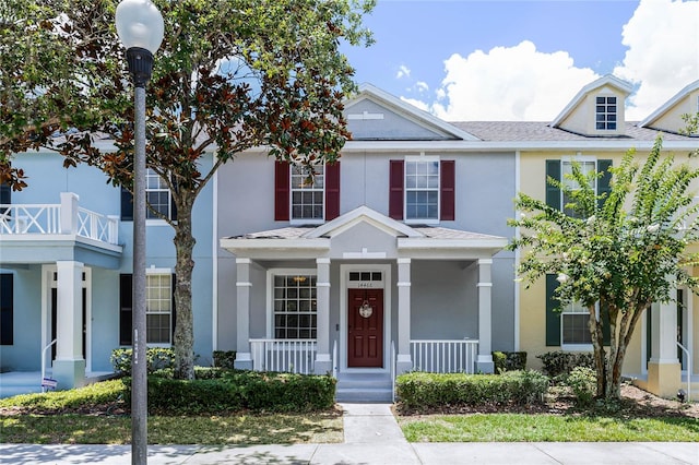 14466 Bridgewater Crossings Blvd, Windermere, FL 34786 - view of property with stucco siding, a porch, and roof with shingles