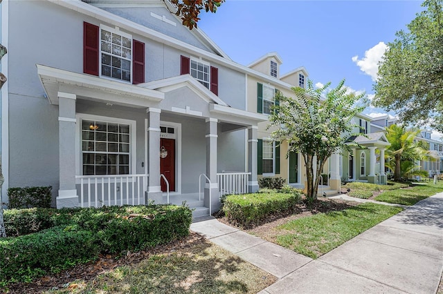 14466 Bridgewater Crossings Blvd, Windermere, FL 34786 - view of front facade with a porch and stucco siding