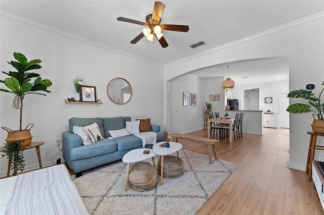 14466 Bridgewater Crossings Blvd, Windermere, FL 34786 - living area with arched walkways, a ceiling fan, light wood finished floors, and crown molding