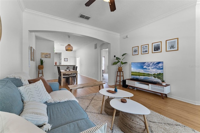14466 Bridgewater Crossings Blvd, Windermere, FL 34786 - living area featuring arched walkways, wood finished floors, a ceiling fan, and crown molding