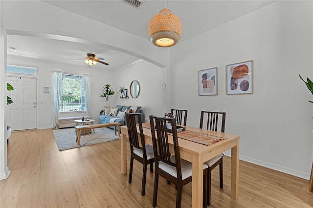 14466 Bridgewater Crossings Blvd, Windermere, FL 34786 - dining space featuring light wood-type flooring, ceiling fan, and arched walkways