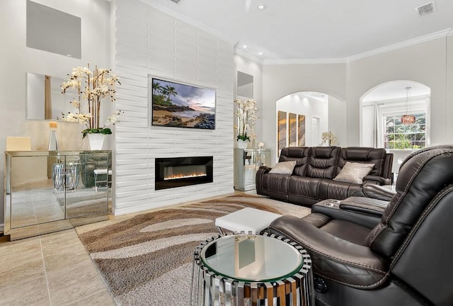 4060 Oak Tree Dr, Davenport, FL 33837 - living room with crown molding, arched walkways, a fireplace, and recessed lighting