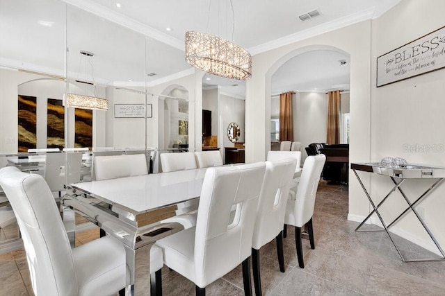 4060 Oak Tree Dr, Davenport, FL 33837 - dining space with crown molding, arched walkways, a chandelier, recessed lighting, and light tile patterned floors
