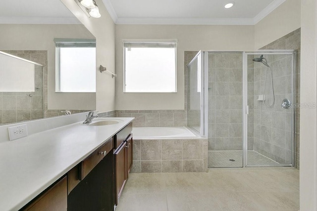 4060 Oak Tree Dr, Davenport, FL 33837 - bathroom with vanity, a shower stall, a bath, tile patterned flooring, and crown molding