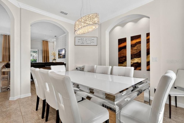 4060 Oak Tree Dr, Davenport, FL 33837 - dining space with crown molding, arched walkways, and light tile patterned floors