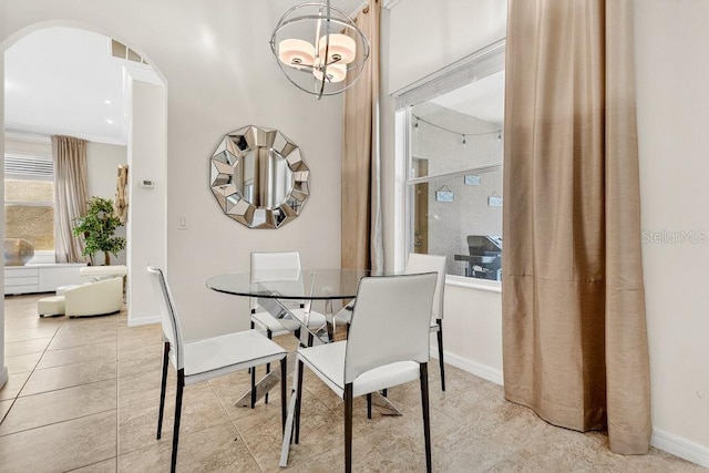 4060 Oak Tree Dr, Davenport, FL 33837 - tiled dining room featuring arched walkways and baseboards