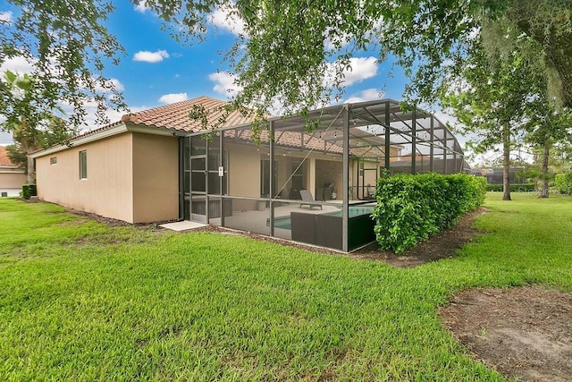 4060 Oak Tree Dr, Davenport, FL 33837 - rear view of house with a tiled roof, a lawn, an outdoor pool, stucco siding, and a lanai