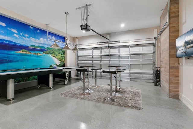 4060 Oak Tree Dr, Davenport, FL 33837 - garage featuring a garage door opener and wood walls