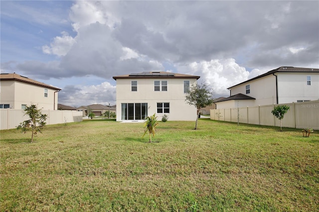 2430 Bittle Way, Saint Cloud, FL 34769 - rear view of house with roof mounted solar panels and stucco siding