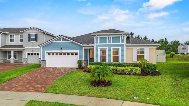 3336 Jackson Bluff Way, Clermont, FL 34711 - view of front of home with decorative driveway, a front yard, an attached garage, and stucco siding