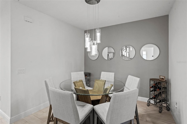 3336 Jackson Bluff Way, Clermont, FL 34711 - dining space featuring light wood-style floors and a chandelier