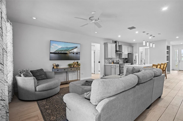 3336 Jackson Bluff Way, Clermont, FL 34711 - living room featuring light wood-style floors, a ceiling fan, and recessed lighting