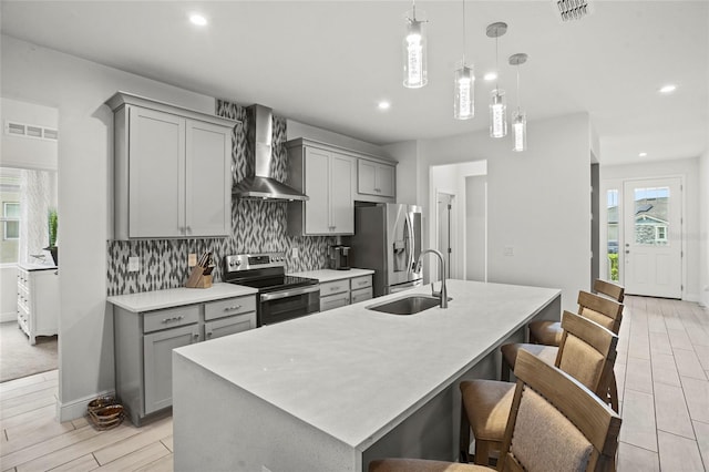 3336 Jackson Bluff Way, Clermont, FL 34711 - kitchen featuring appliances with stainless steel finishes, wall chimney exhaust hood, gray cabinetry, tasteful backsplash, and recessed lighting