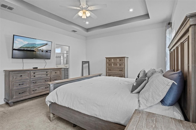 3336 Jackson Bluff Way, Clermont, FL 34711 - bedroom with light colored carpet, recessed lighting, a tray ceiling, a ceiling fan, and ensuite bath