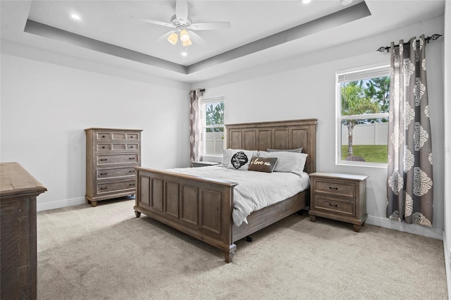 3336 Jackson Bluff Way, Clermont, FL 34711 - bedroom featuring a tray ceiling, light colored carpet, a ceiling fan, and recessed lighting