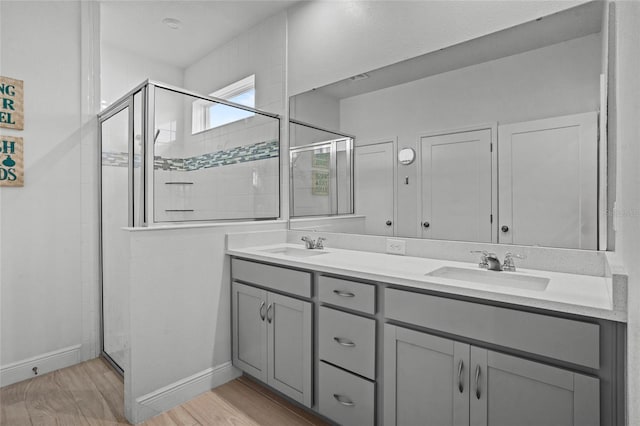 3336 Jackson Bluff Way, Clermont, FL 34711 - full bathroom with double vanity, a shower stall, and wood finished floors