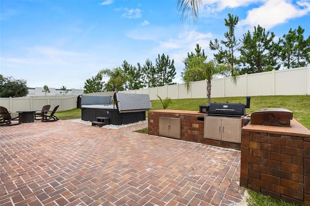 3336 Jackson Bluff Way, Clermont, FL 34711 - fenced backyard featuring exterior kitchen, a patio, a hot tub, and a fire pit