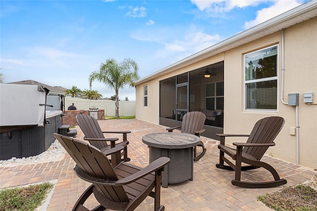 3336 Jackson Bluff Way, Clermont, FL 34711 - fenced backyard featuring an outdoor fire pit, a hot tub, a patio area, and a sunroom