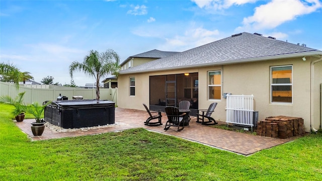 3336 Jackson Bluff Way, Clermont, FL 34711 - back of house featuring stucco siding, a patio area, a hot tub, and a shingled roof